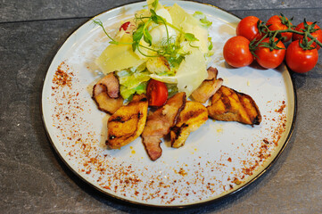 Delicious, beautiful, fresh salad in a plate on a wooden restaurant table