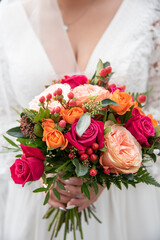 bride holding bouquet of roses