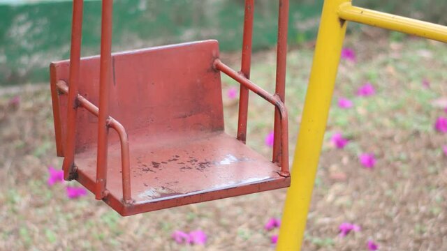 self-swinging playground swing in poor condition 