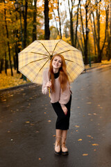 red-haired girl in autumn Park. autumn photo shoot