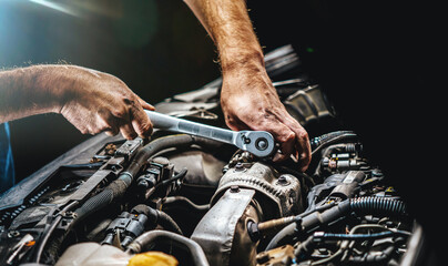 Auto mechanic working in garage. Repair service.