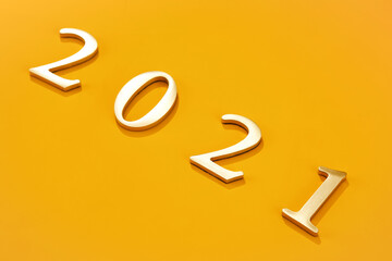 2021 made with plastic numbers on a yellow background