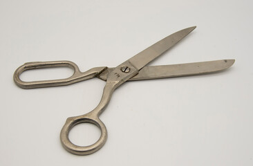 Old tailor scissors on a white background.