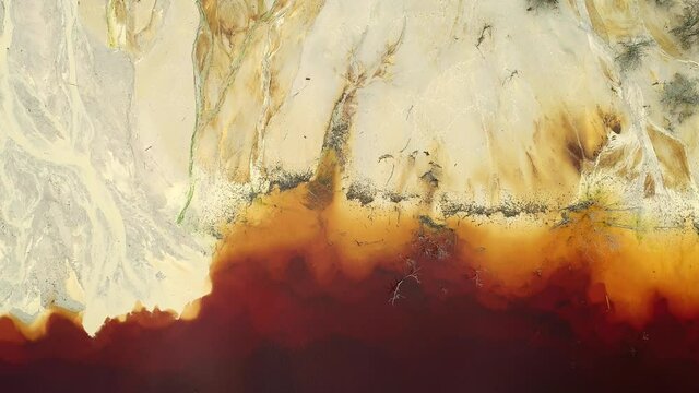 Aerial footage over cooper mine industrial waste lake from Romanan village Geamana in Apuseni mountains . Rosia Montana