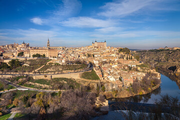 Fototapeta na wymiar Beautiful view of Toledo city skyline with Cathedral, Alcazar and Tagus River with blue sky and clouds, Spain