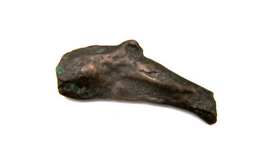 antique copper coin in the shape of a dolphin on a white background