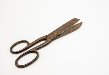 Old tailor scissors on a white background.