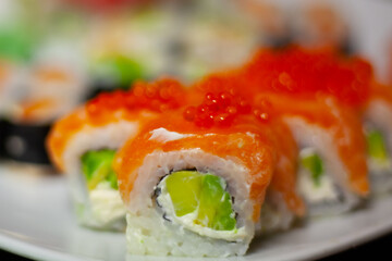 Slightly blurred Sushi beautifully decorated dish on the table