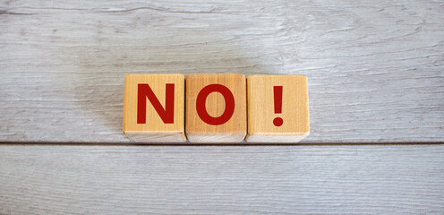 Wood blocks with word 'no' on white wooden background, copy space. Business concept.