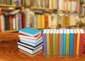 Stack open old books on wooden desk
