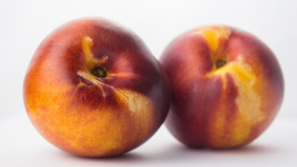 Fototapeta na wymiar Fresh juicy peaches on a white plate. Close-up Fresh organic peaches nectarine on a white plate.