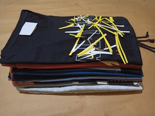T-shirts arranged, with different colors. isolated on brown background.