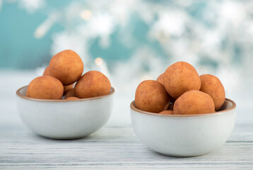 Marzipan potatoes, in german called Marzipankartoffeln, with cacao powder, sweets for christmas, empty copy space