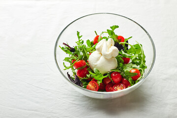 Burrata, Italian fresh cheese made from cream and buffalo or cow milk, with tomato, arugula and red basil salad