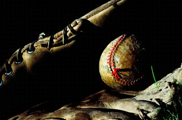 Baseball & Glove at Seasons End - Late sunlight highlites the glove, ball and worn stiches