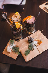 Christmas winter mulled wine in beautiful glasses and gift envelopes in craft paper. friendly gatherings