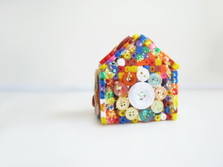 Hand-made home made from thermomosaic material. Children made figurines from thermomosaic....