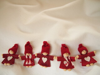 christmas card, little red elfs with white heart on dress and knitted hat on white background, winter background