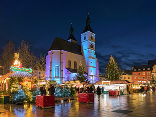 Regensburg, Germany. The city's main Christmas market on the Neupfarrplatz (New Parish Square) around the Neupfarrkirche (New Parish Church) in dusk.
