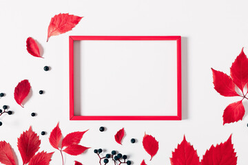 Autumn minimal composition. Colorful red leaves, photo frame on white background. Fall leaves. Autumn background. Flat lay, top view, copy space