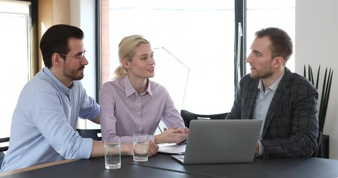 Happy young caucasian family couple consulting with financial advisor about savings investment. Confident male lawyer showing services presentation on computer to clients at modern workplace.