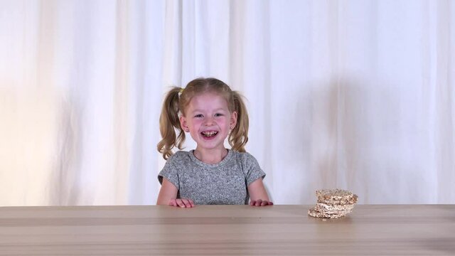 Cheerful little girl and healthy food. Happy baby and healthy snack. Snacks. Crunchies. High quality 4k footage