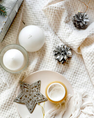 Details of still life in the home interior living room. Orange Opened plastic container, jar.of cream over Christmas lights bokeh in home. holiday decoration, magic Christmas. Selected focus