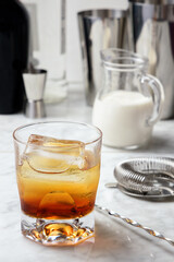 Glass with a mixture of vodka and coffee liqueur. White Russian cocktail preparation