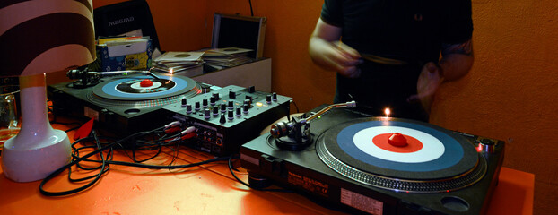 Record player with DJ in a club // Plattenspieler mit DJ in einem Club