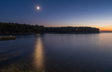 Fototapeta premium Stone pier on beach Vela Luka in long exposure. Croatia, Brac island, Supetar at night. August 2020