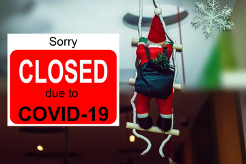 Business center closed due to COVID-19, sign with sorry in door window. Stores, restaurants,...