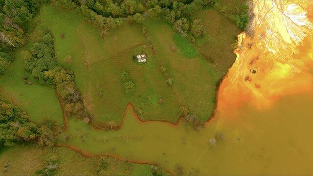 Aerial footage over cooper mine industrial waste lake from Romanan village Geamana in Apuseni mountains . Rosia Montana 