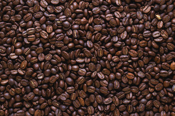 coffee beans background. Overhead macro shot of coffee seeds. Flat lay of the roasted coffee beans