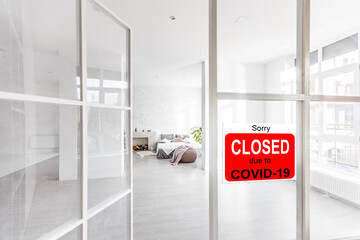 Business center closed due to COVID-19, sign with sorry in door window. Stores, restaurants,...