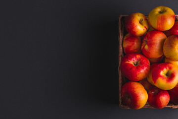 Overhead shot of red apples on the dark grey background with free space for text