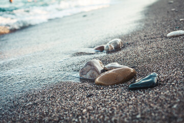 Waves hitting sea shore. coast line with rocks and pebbles