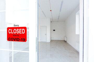 Business center closed due to COVID-19, sign with sorry in door window. Stores, restaurants,...