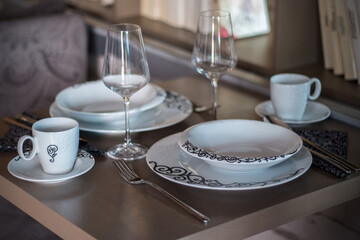 Set of porcelain tableware, prepared on a table in a modern restaurant.