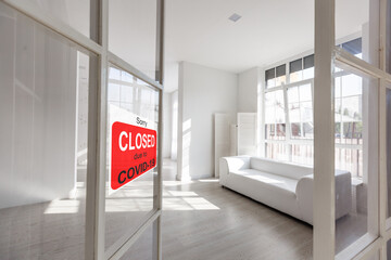 Business center closed due to COVID-19, sign with sorry in door window. Stores, restaurants,...