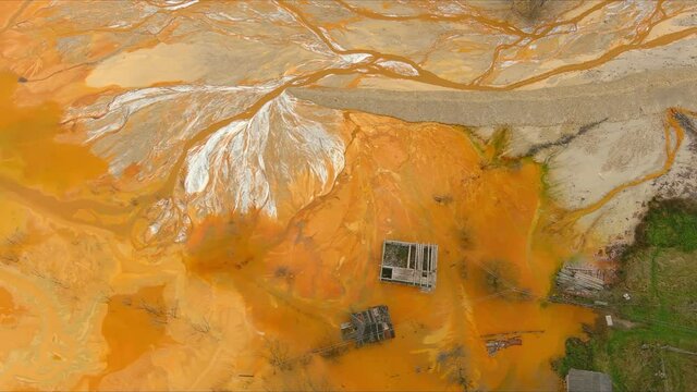 Aerial footage over cooper mine industrial waste lake from Romanan village Geamana in Apuseni mountains . Rosia Montana 