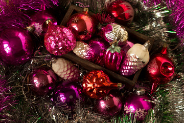 Old New Year's toys from the USSR times in the form of cones, snowflakes. Christmas pink, crimson...