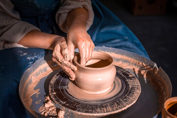Young lady enjoying pottery art and production process. Artisan production. Close-up.