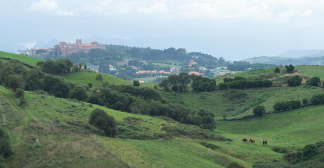 Fototapeta na wymiar Green hills and meadows nearby the town of Comillas, cantabria, Spain