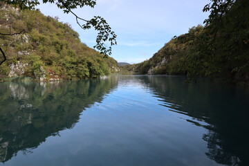 Panorama of the lake with clear calm water in which the sky and mountains are reflected, Plitvice Lakes National Park