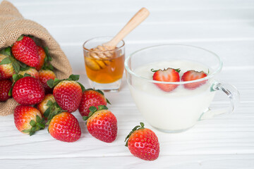 Fruit yogurt has strawberry and honey greek white clean In bowl on a wooden background from top view.
