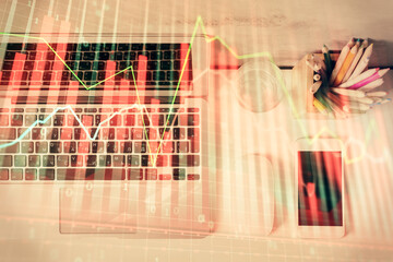 Multi exposure of forex graph drawing over desktop background with computer. Concept of financial analysis. Top view.