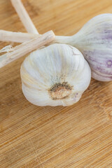 three heads of garlic whole close-up strongly smelling vegetable