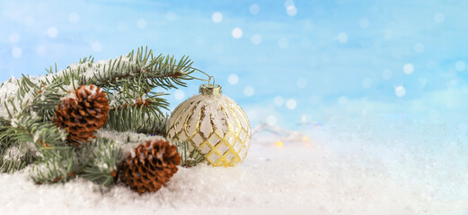 Holiday Christmas background. Christmas card background with Christmas background with golden ball. Christmas theme, fir branches and ball. Snow. copyspace