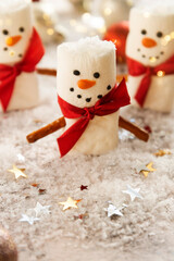 Marshmellow snowmen with snow and gliter, Christmas food background