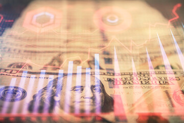 Double exposure of forex graph drawing over us dollars bill background. Concept of financial...